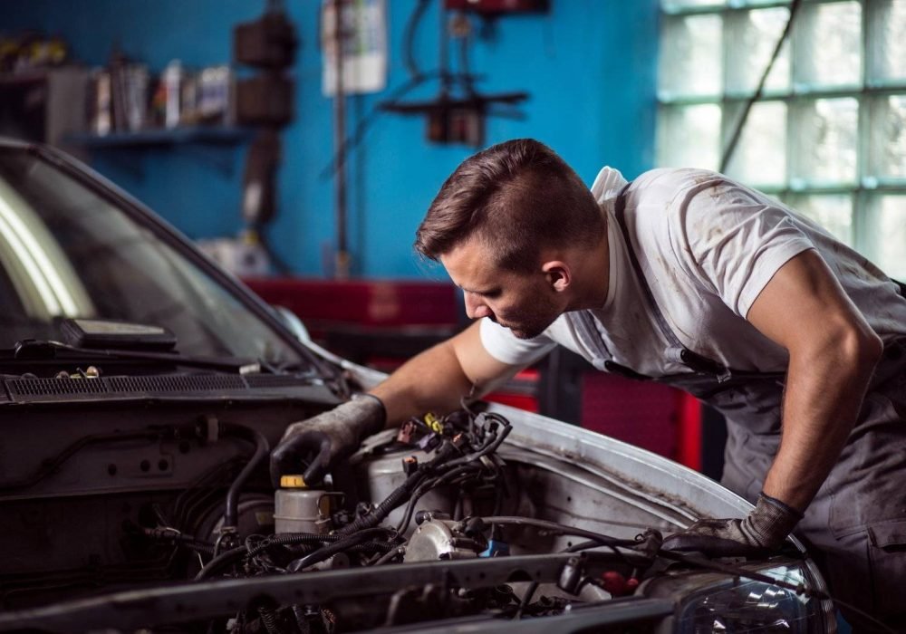 Picture of car mechanic repairing broken vehicle